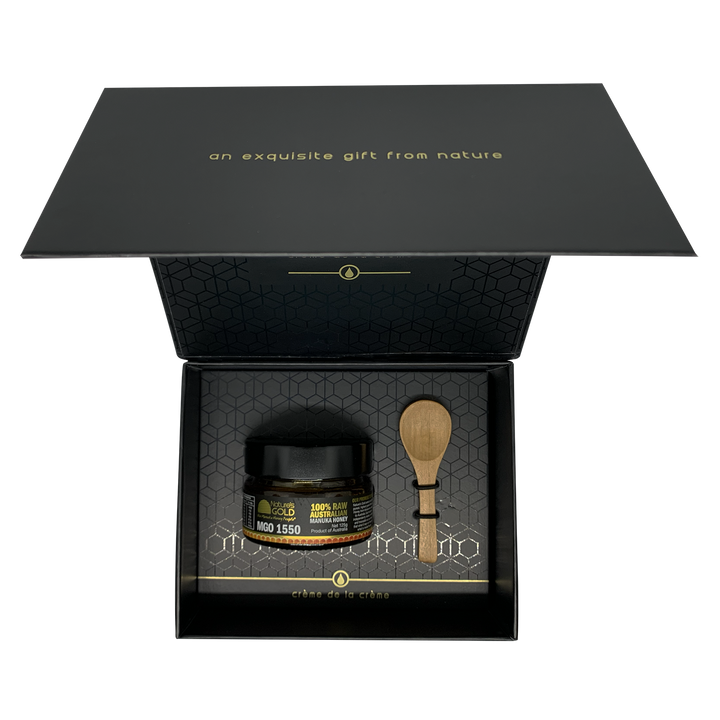 Creme de la creme premium MGO1550 open box with a bottle of manuka honey and spoon