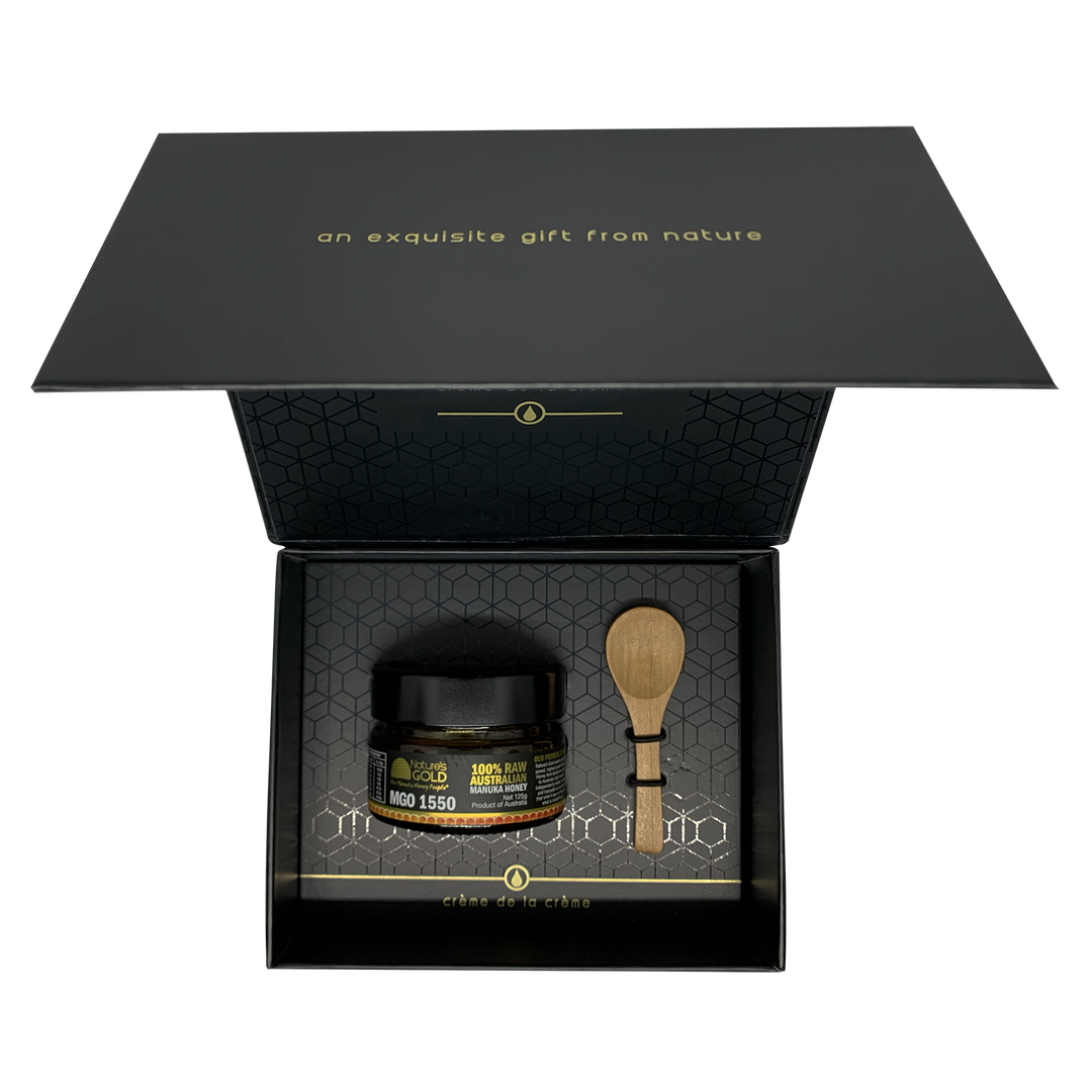 Creme de la creme premium MGO1550 open box with a bottle of manuka honey and spoon