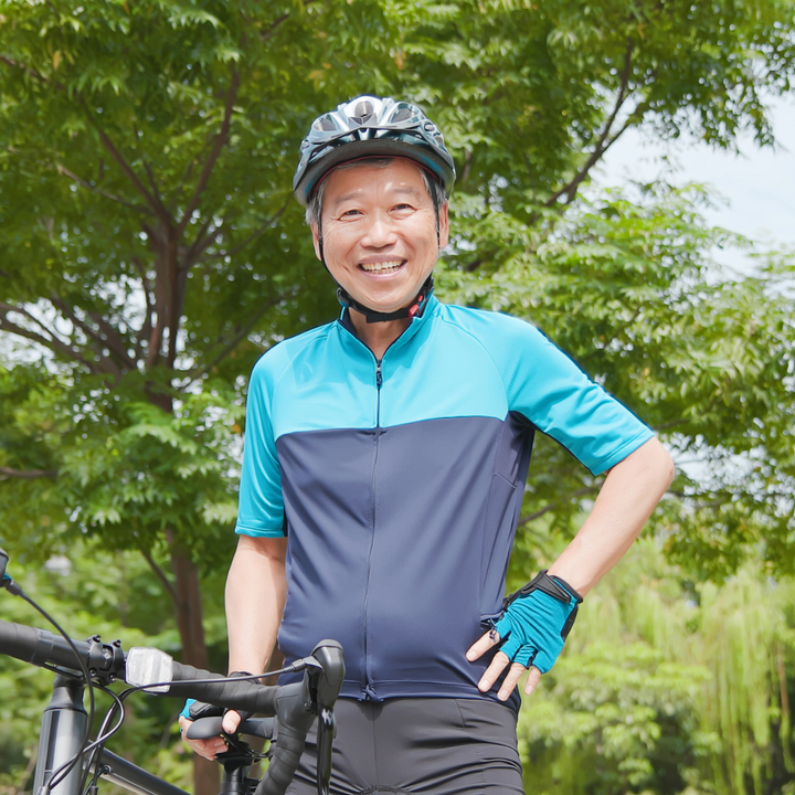 Asian man in blue on bicycle 