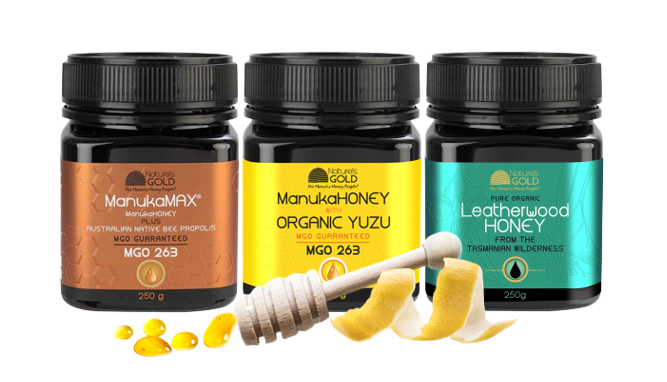 A gift pack set of three bottles with three color labels with honey spoon