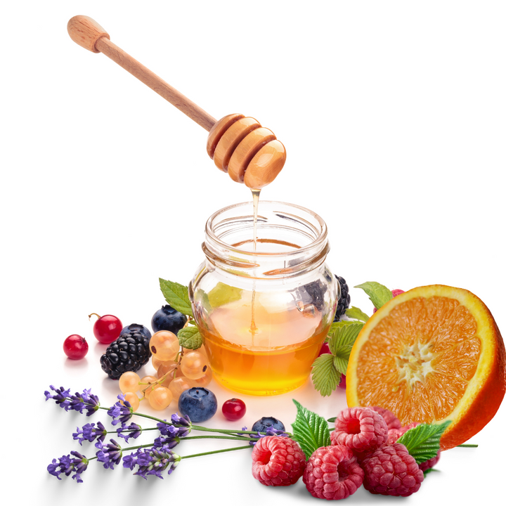 A bottle of raw honey with lavender flower, orange, and other berries on white background