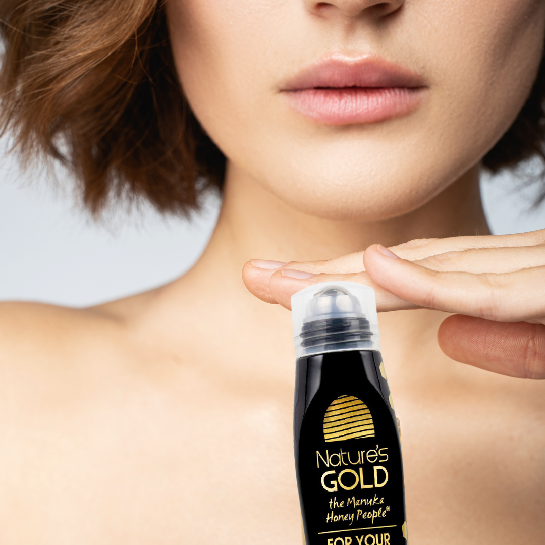 A lady with the Nature's Gold For Your Eyes roller bottle