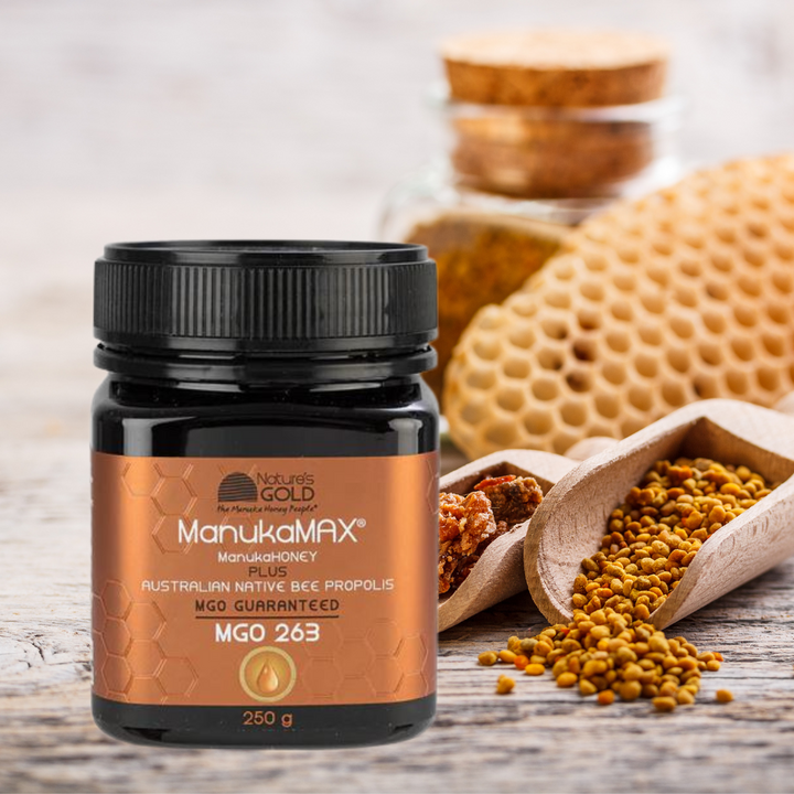 ManukaMAX, manuka honey plus Australian native bee propolis MGO253 - with honey and grains on background